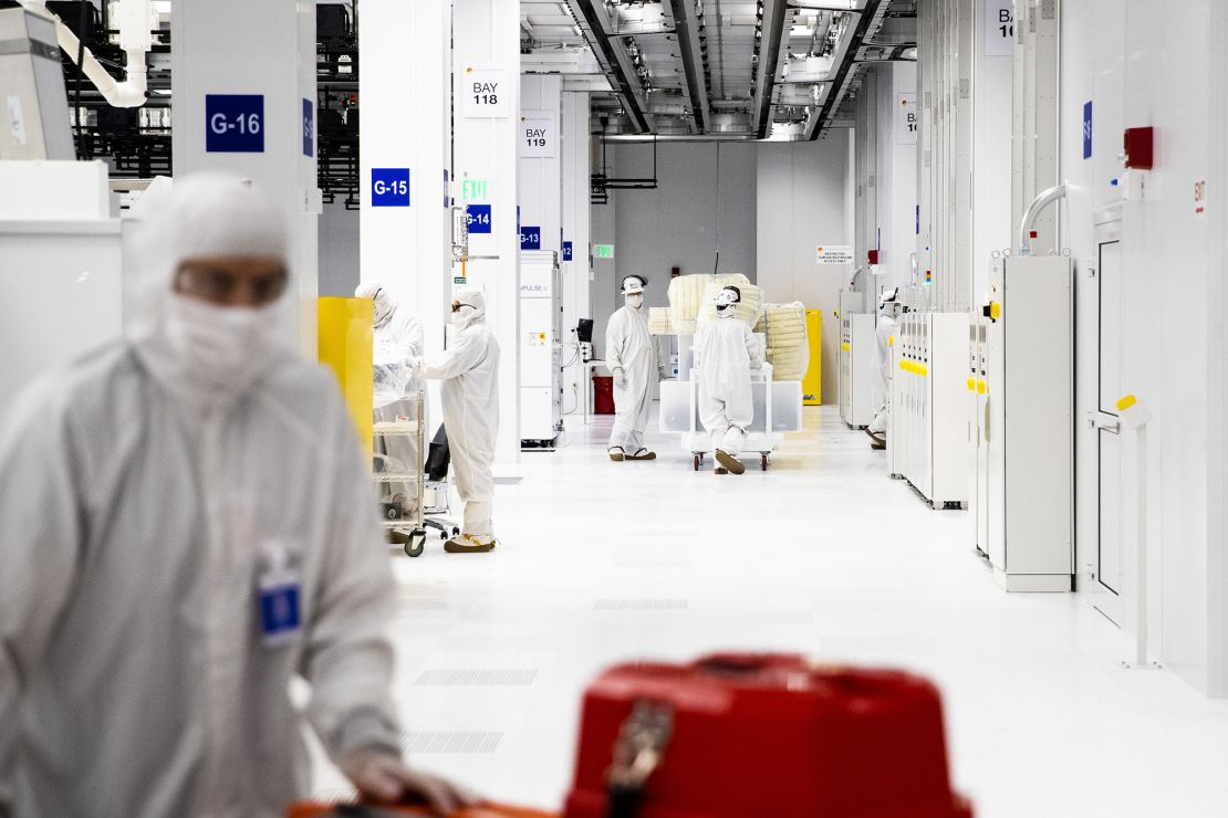 Employees wearing cleanroom suits work at the main bay inside the GlobalFoundries semiconductor manufacturing facility in Malta, New York, U.S., on Tuesday, March 16, 2021. Production plants for semiconductors have become a focal point as the economic recovery from the pandemic is held back in areas by a shortage of some of the critical electronic components necessary. Photographer: Adam Glanzman/Bloomberg via Getty Images